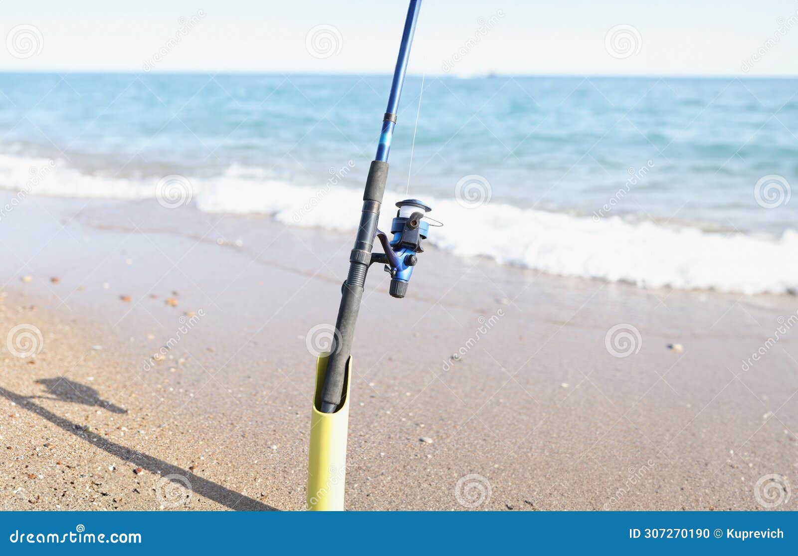 The Fishing Rod Stands on the Sand on the Seashore, Blurry Stock Photo -  Image of pond, water: 307270190