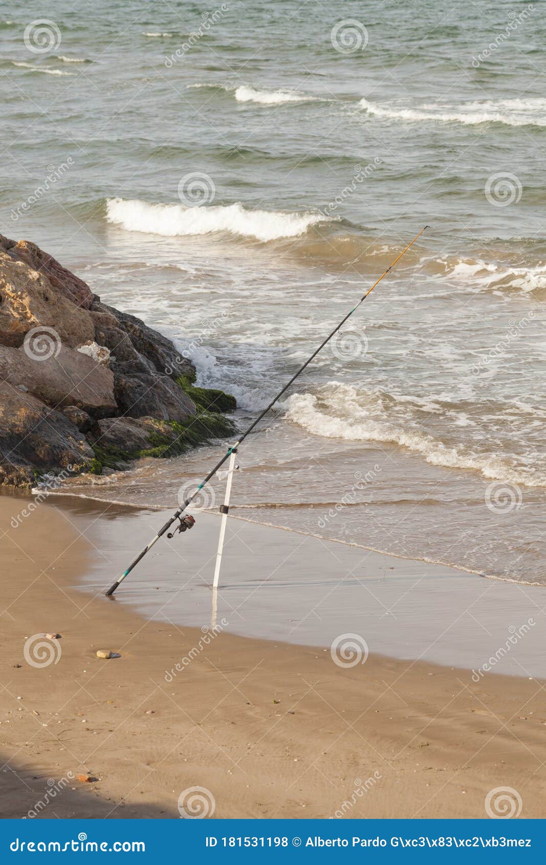 Fishing Rod Stuck in the Ground beside the Sea Stock Photo Image of