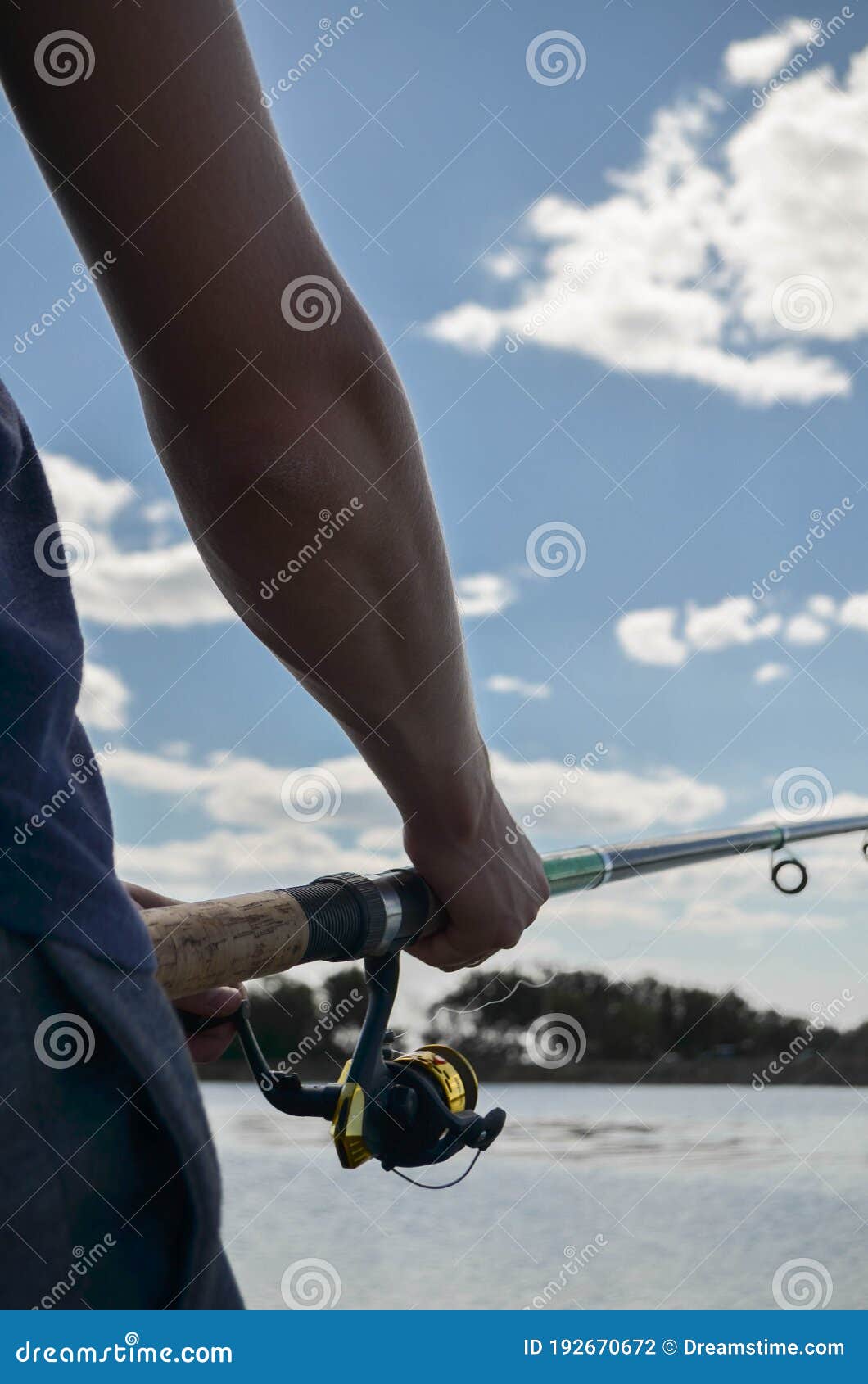 Fishing Rod Wheel Close-up in the Hands of a Young Man Stock Photo - Image  of lure, hook: 192670672