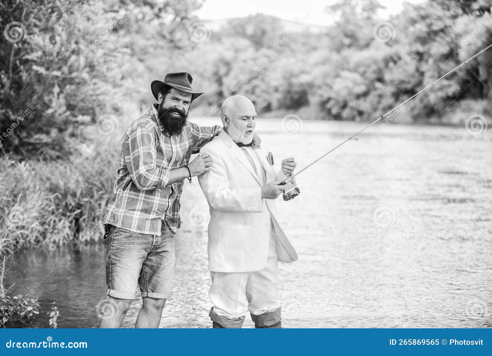 fishing school. mature man fisher celebrate retirement. two fishermen with fishing reel. family, granddad and drandson