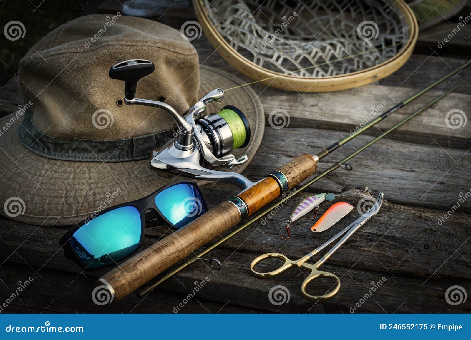 Vintage fly fishing equipment on top of large trout in riverbed