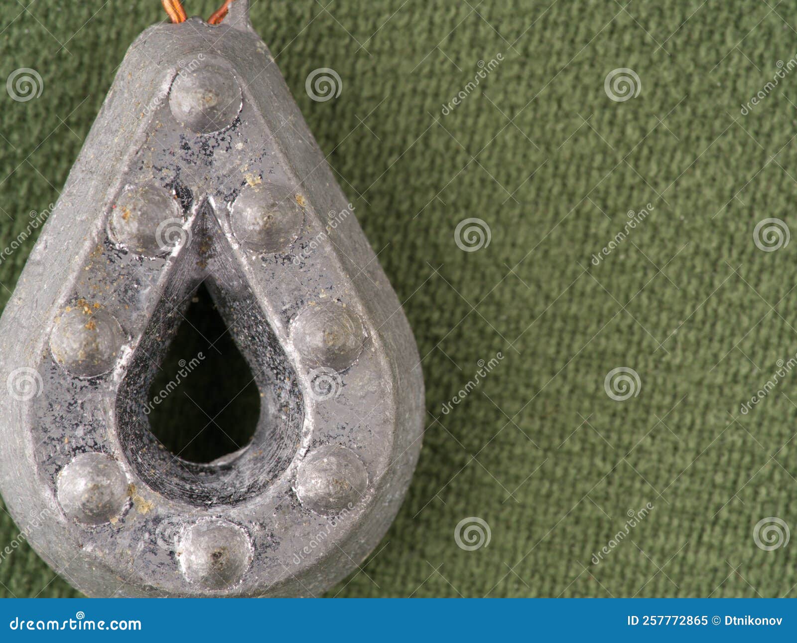A Fishing Weight with an Eye for Attaching a Fishing Line. Closeup