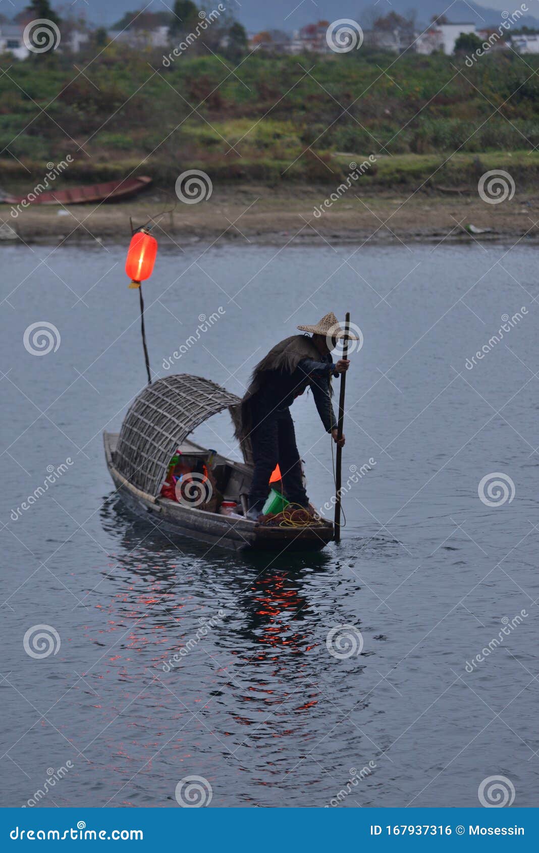 fishman rowing boat in canoe lantern