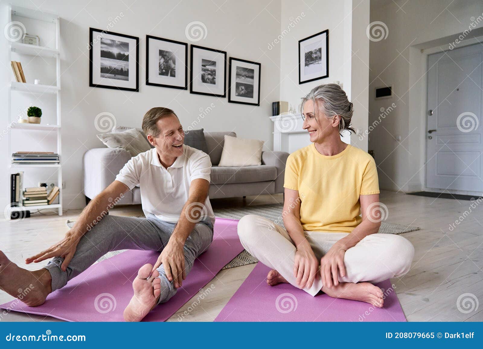 fit active mature wife and senior husband having fun exercising at home.