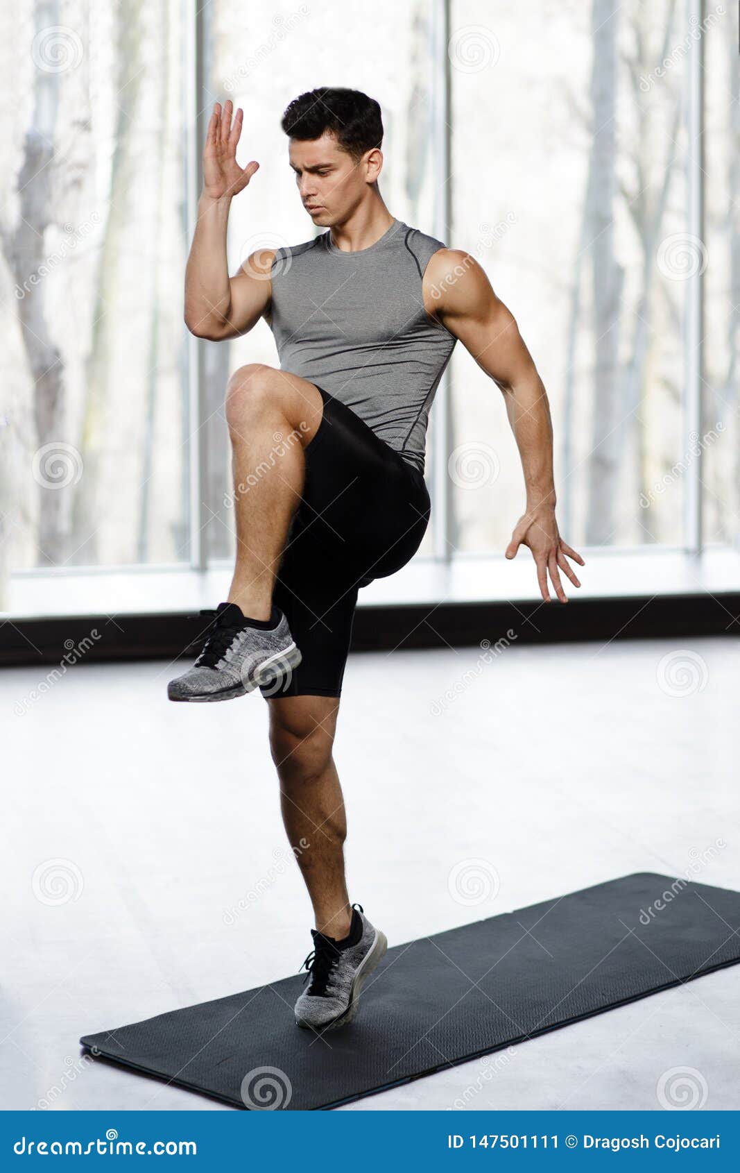Fit, Athletic Male Model in Sportswear Doing Strength Exercise with Knee Up  in Gym, Isolated on a Big Window Background. Stock Image - Image of athlete,  indoors: 147501111