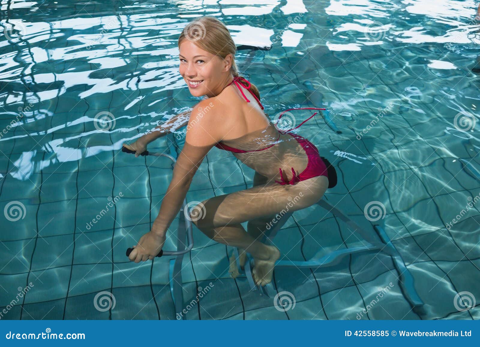 Fit Happy Blonde Using Underwater Exercise Bike S