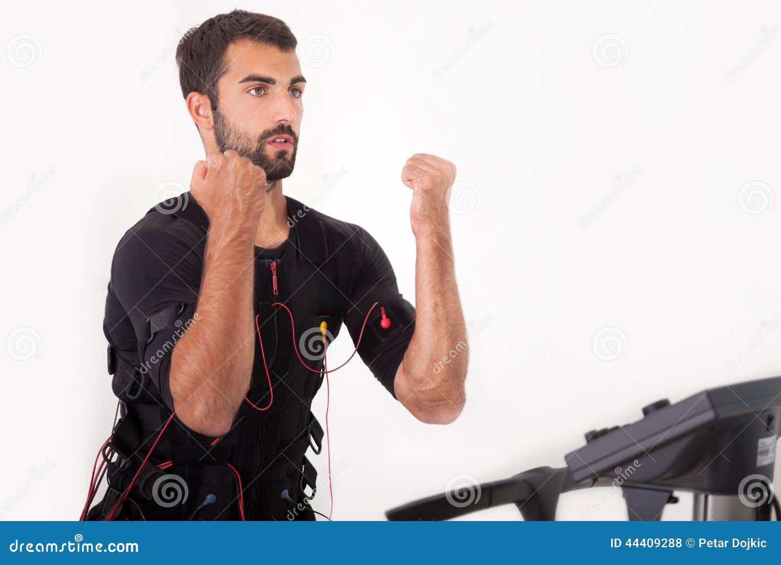 Fit Man Exercise on Electro Muscular Stimulation Machine Stock Photo