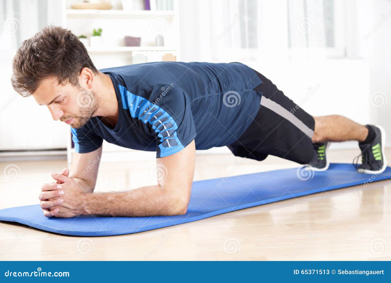 fit man in planking exercise facing the floor