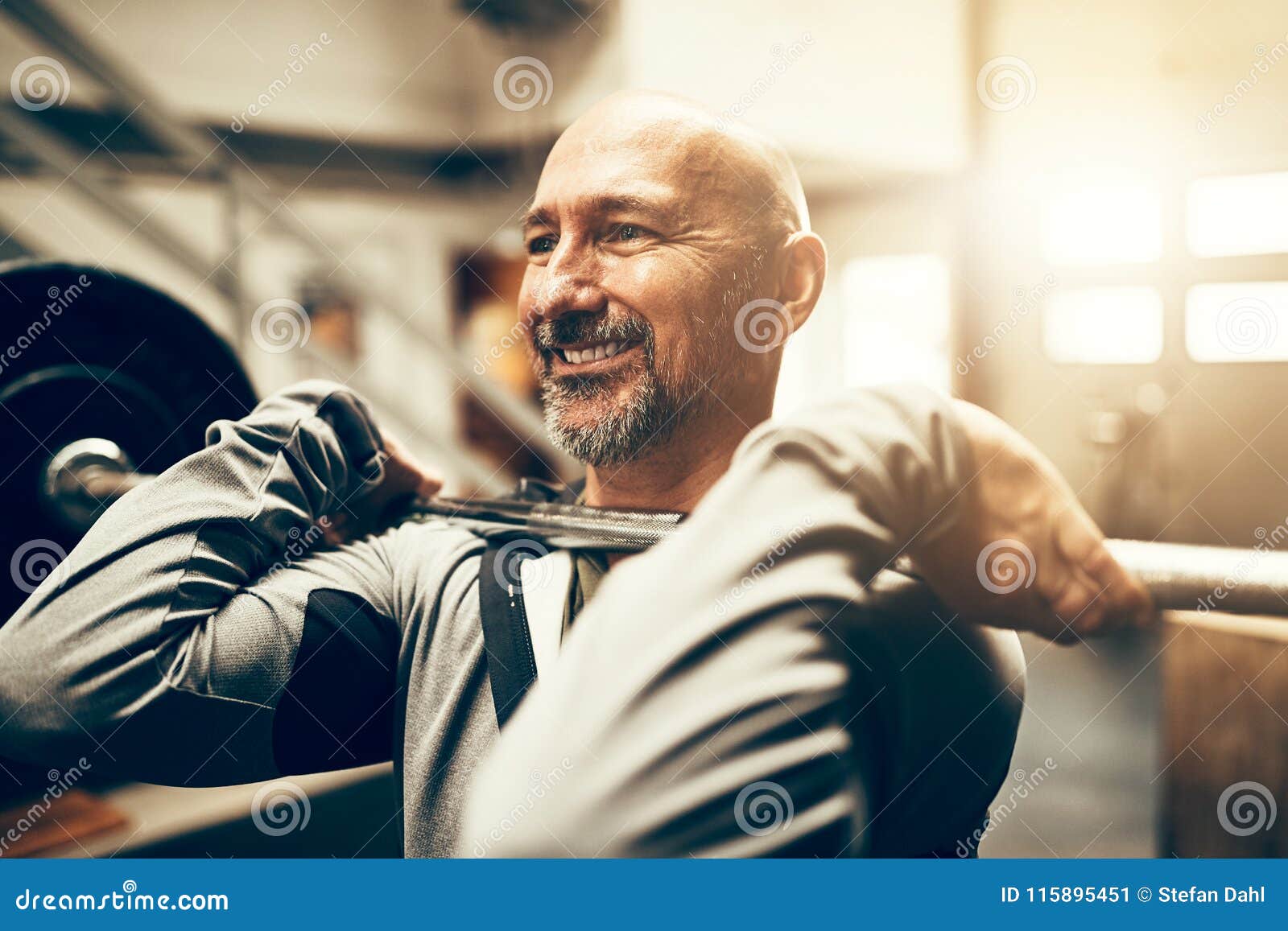 Fit Mature Man Smiling and Lifting Weights in a Gym Stock Image - Image ...