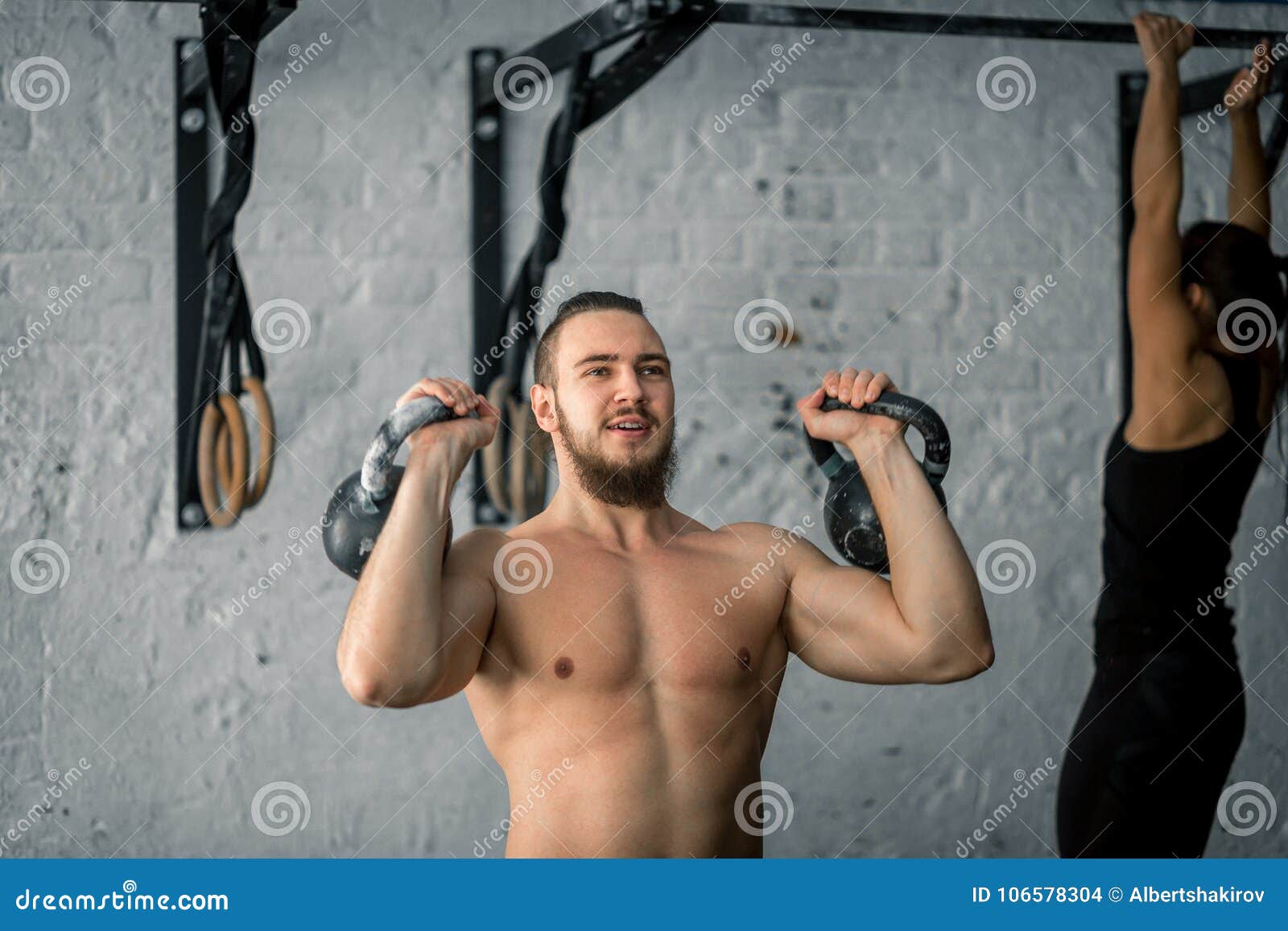 Man Lifting Two Kettlebell Workout Exercise at Gym Stock Photo Image