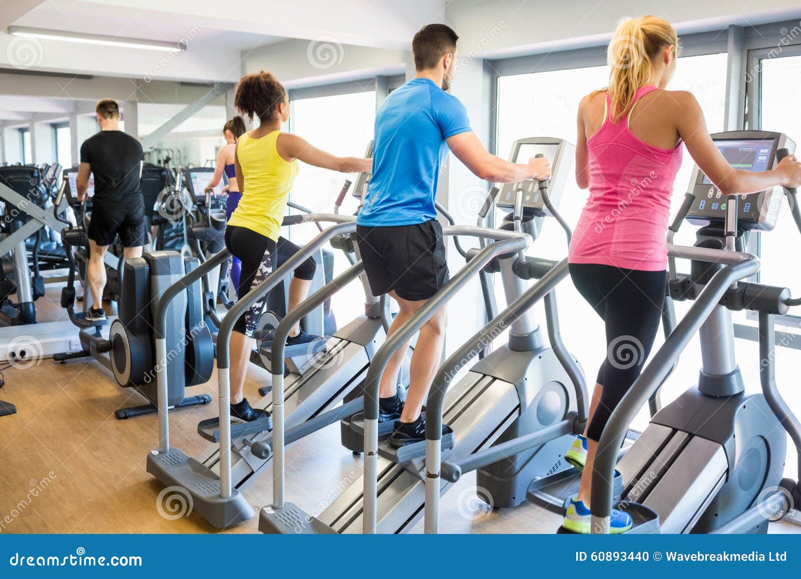 Fit People Working Out Using Machines Stock Photo Image of club