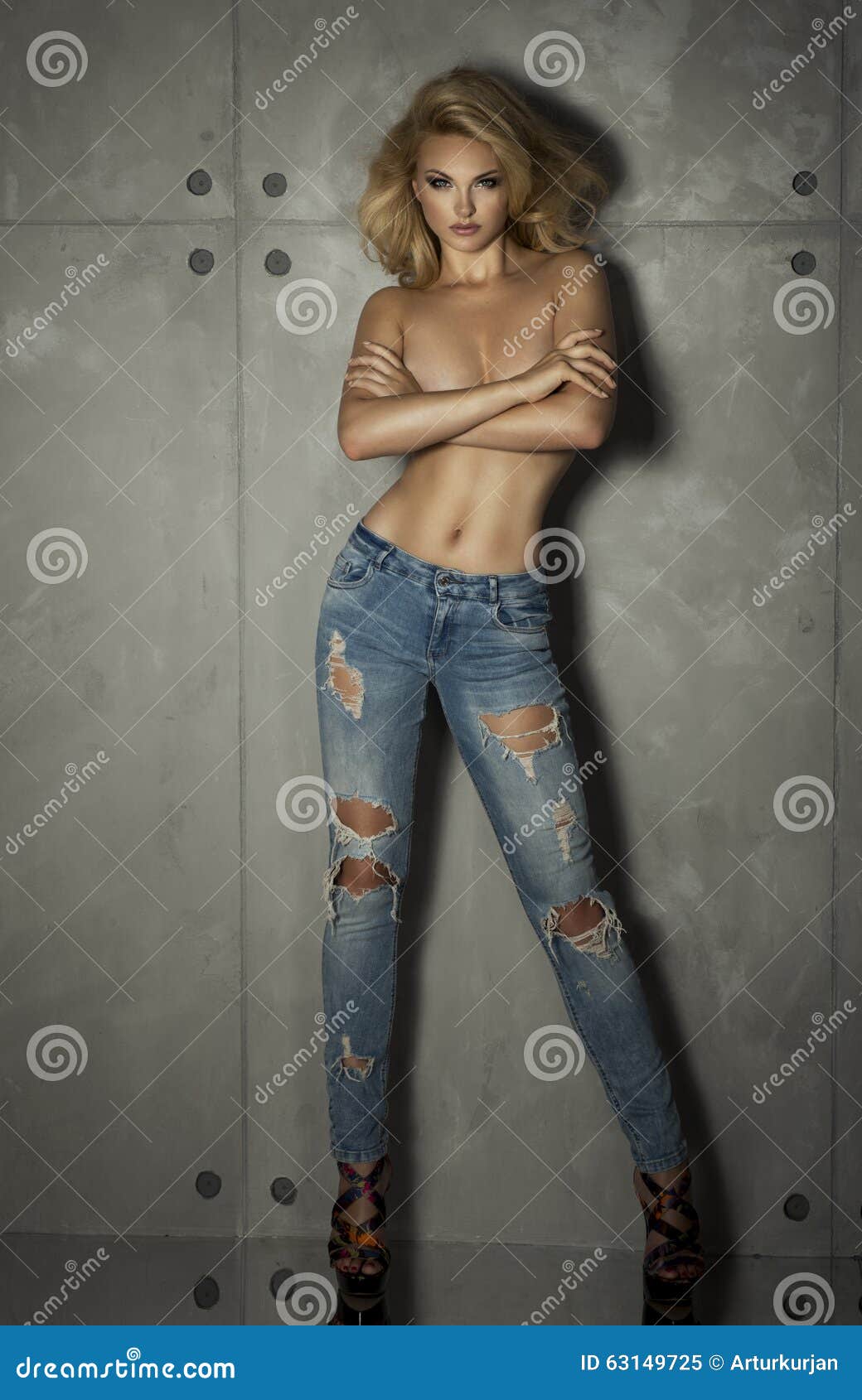 Young, fit and woman only in jeans. 