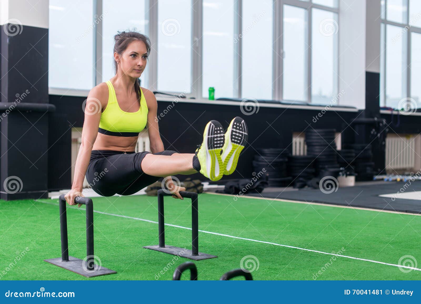 Fit Strong Woman Doing L-sits Work-out in Gym, Lifting Up Her Legs