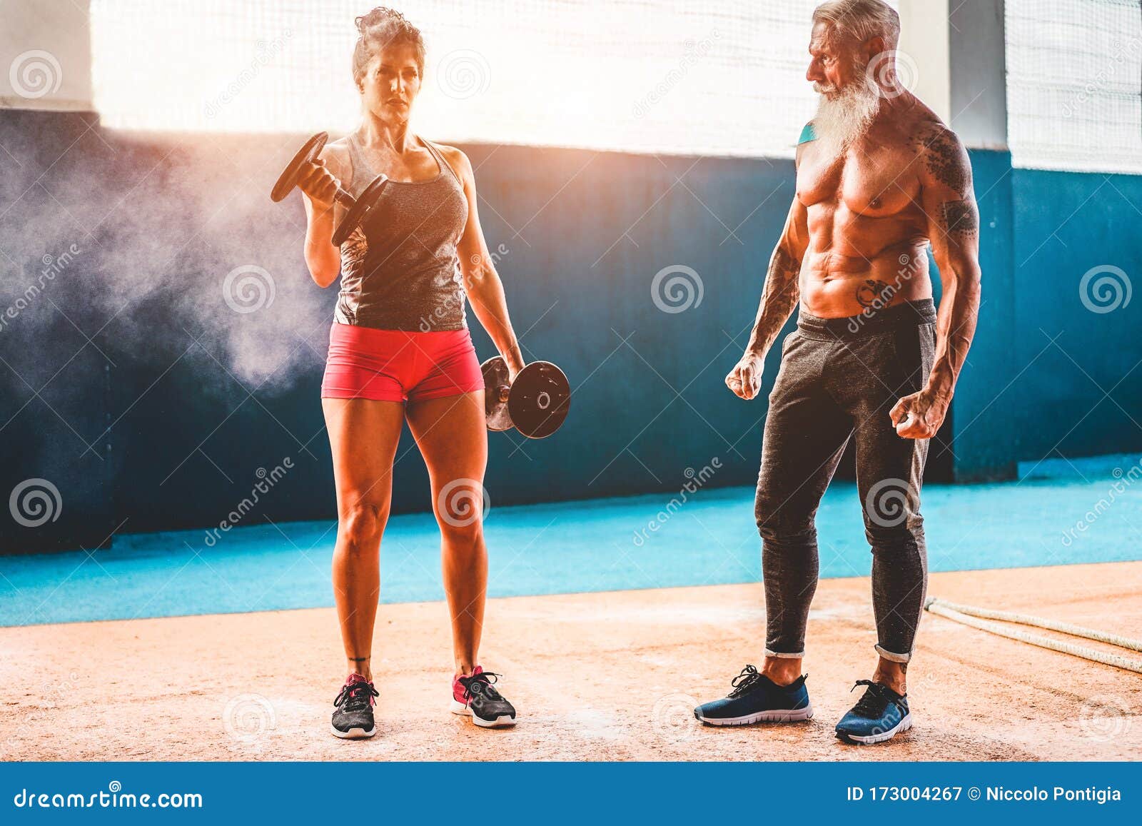 fit-woman-with-dumbbells-in-functional-training-fitness-gym-tattooed