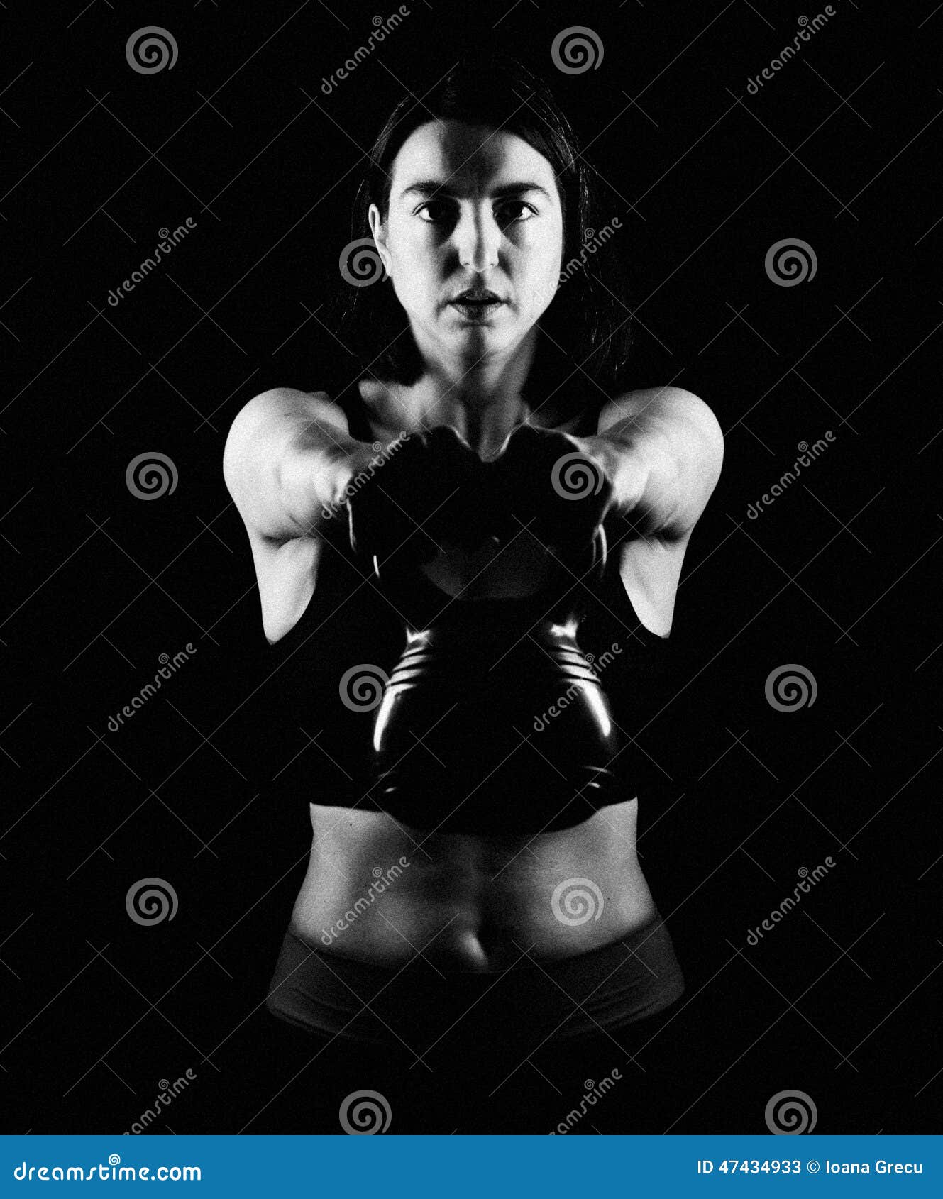 fit woman lifting kettle bell