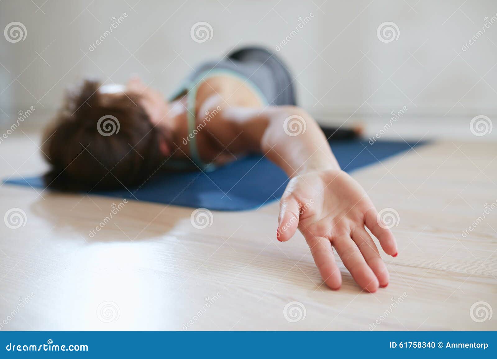 Fit woman in a meditative yoga pose at gym. Portrait of fit mature woman in a meditative yoga pose at gym. Healthy female model doing padmasana at health club.