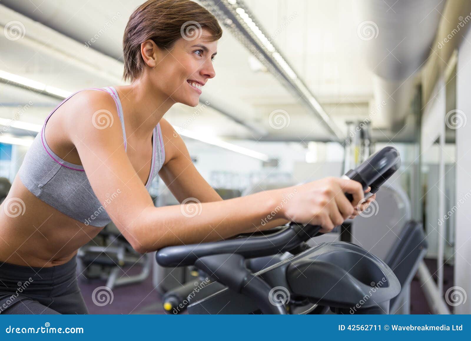 Fit Woman Working Out on the Exercise Bike Stock Image - Image of ...