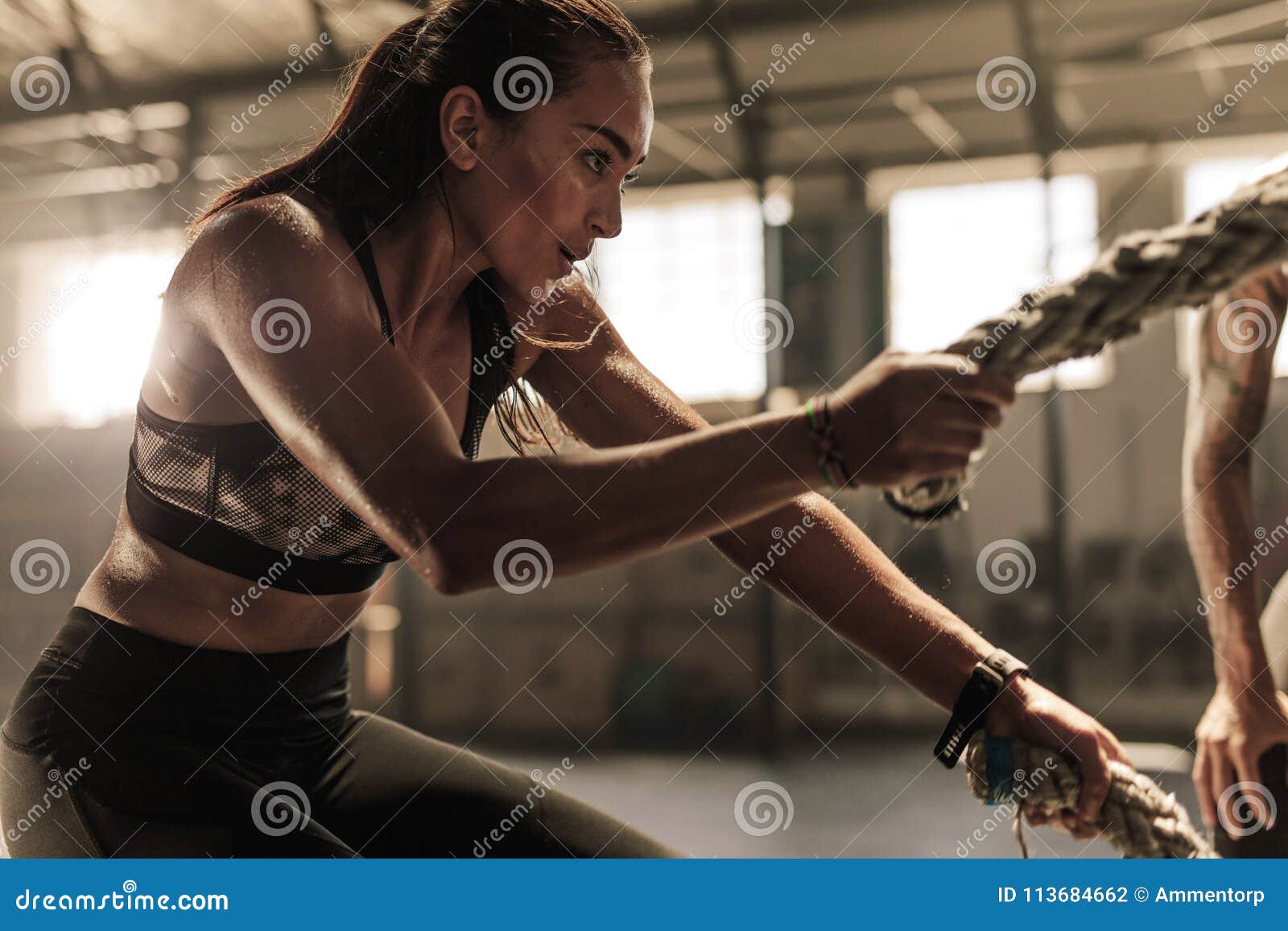 Woman Doing Strength Training with Battle Ropes Stock Photo - Image of  lifestyle, concentration: 113684662