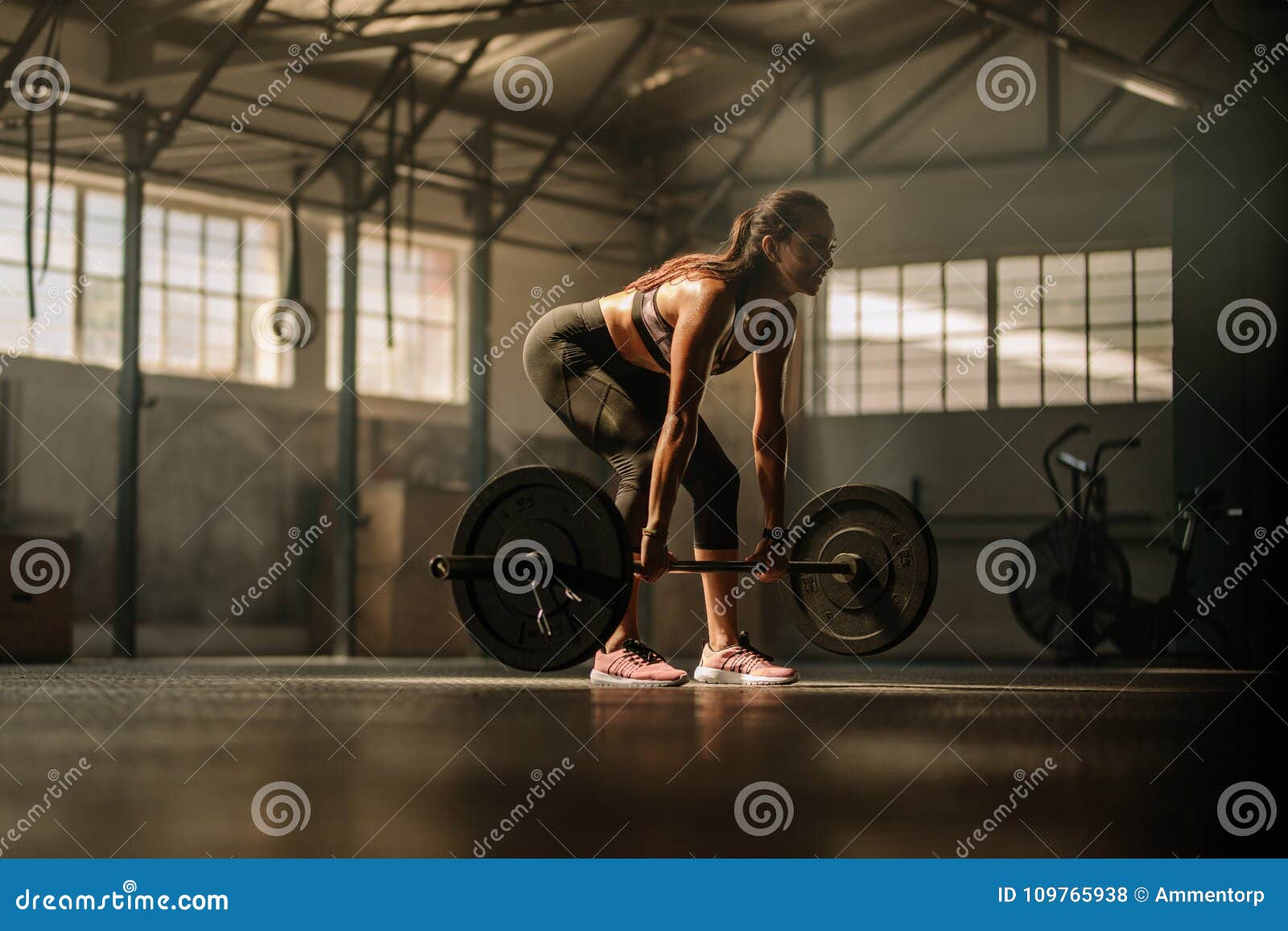 Fitness Model Performing Weight Lifting Exercise at Gym Stock Photo ...