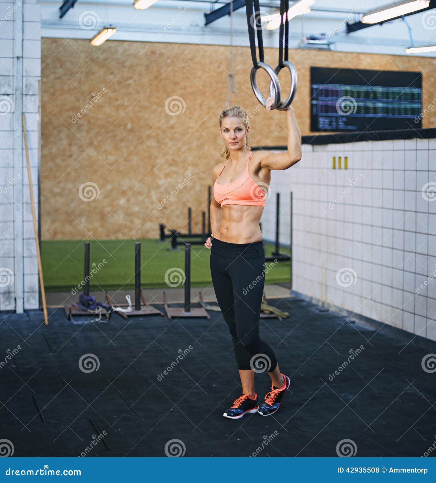 Working out Young athletic sportswoman exercising on gymnastic