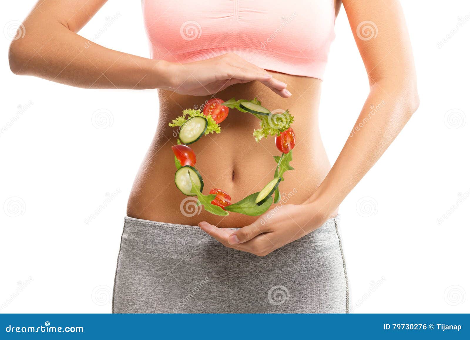 fit, young woman holding a circle made out of vegetables
