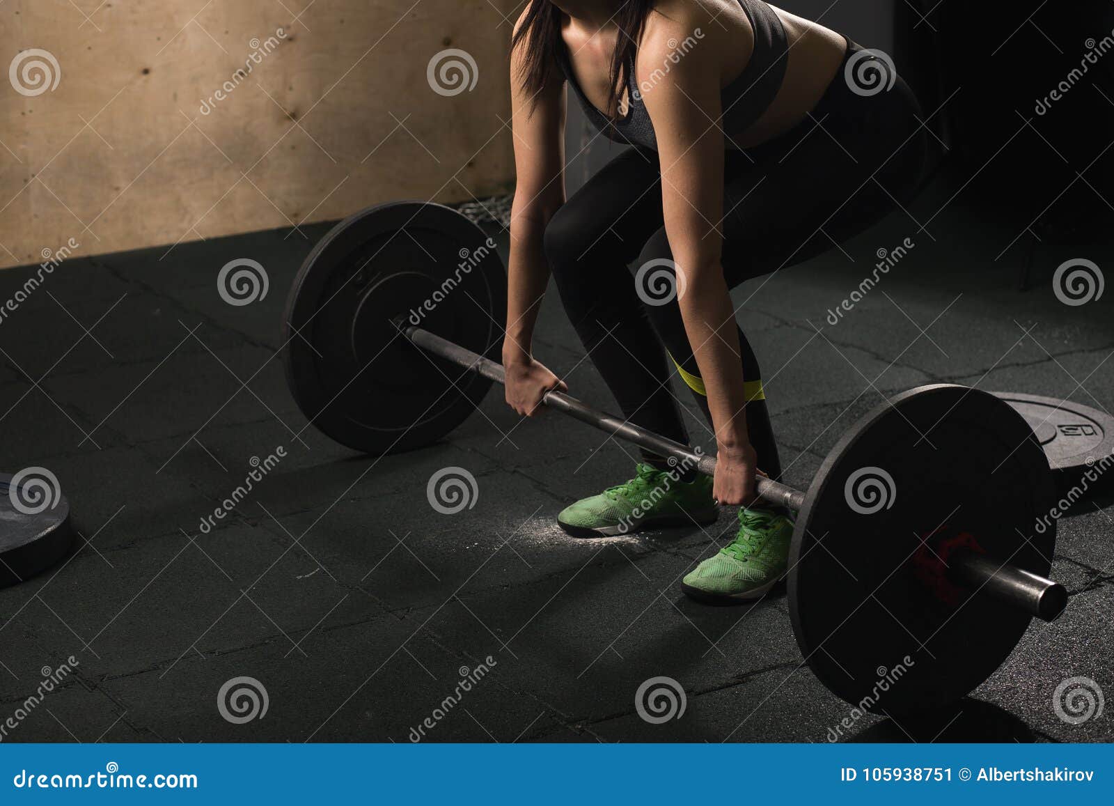 Muscular Woman in a Gym Doing Heavy Weight Exercises with Barbell Stock ...