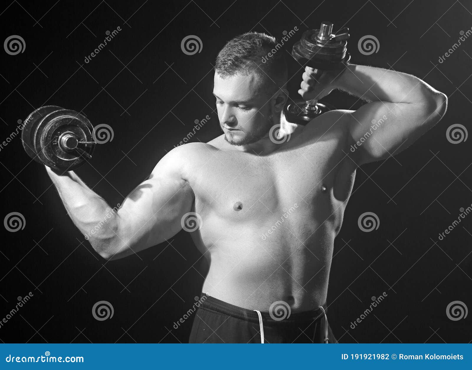 Fitness Big Powerful Muscular Man Lifting Weights. Stock Photo