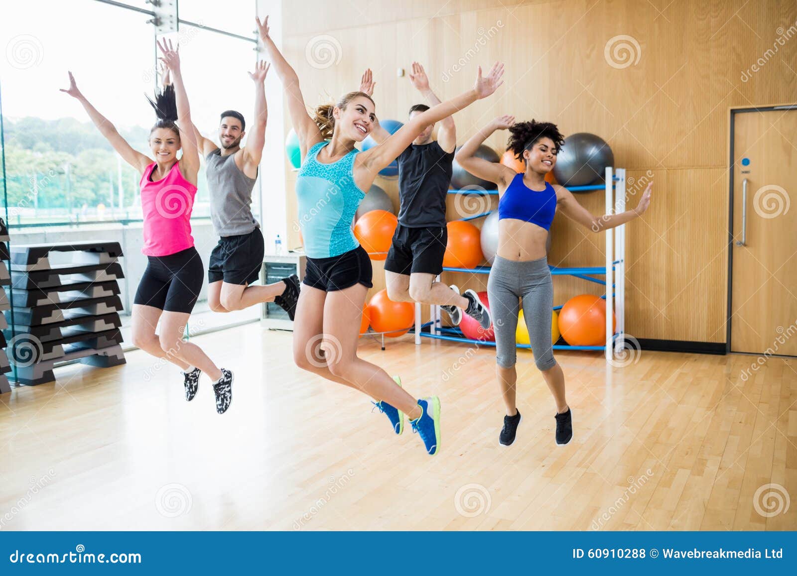Fitness Class Jumping Up in Studio Stock Photo Image of friend, five
