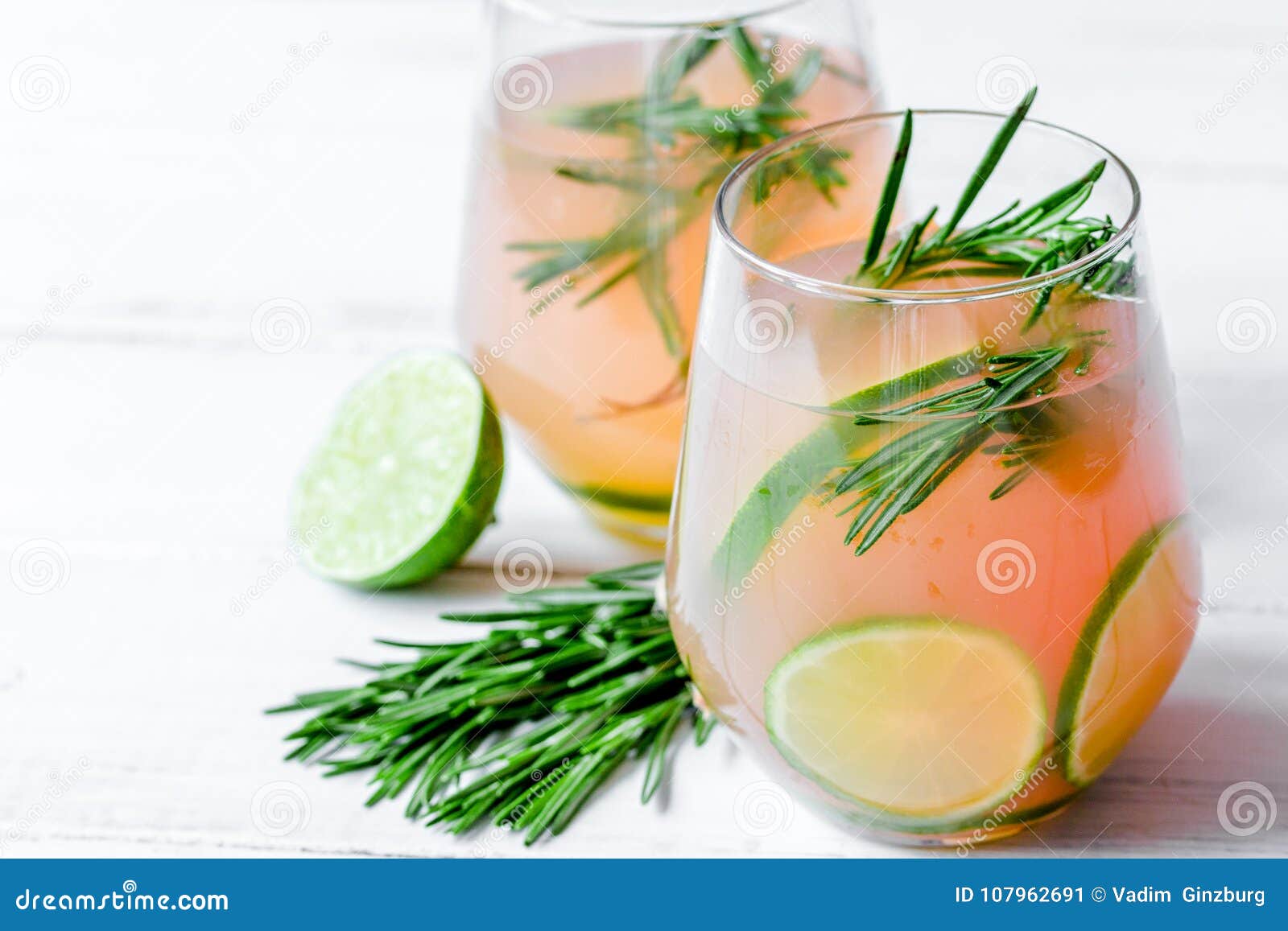 Fitness Cocktail in Glass with Lime and Rosemary on White Table Stock ...