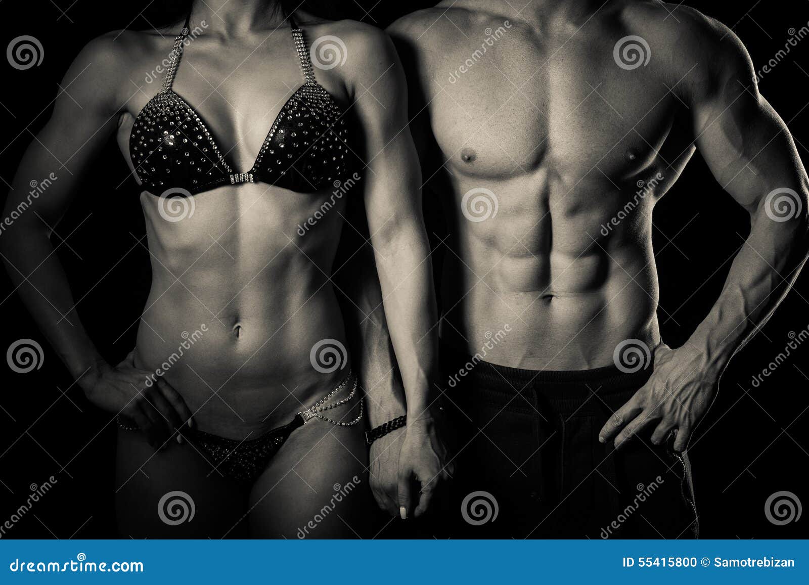 fitness couple poses in studio - fit man and woman