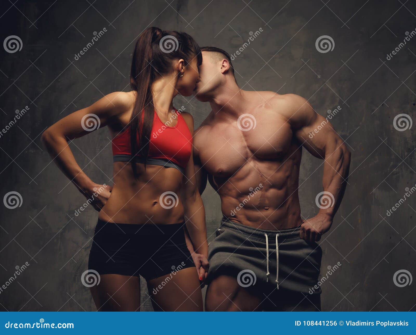 Shirtless Bodybuilder And Fitness Woman Kissing Each Other Stock Photo