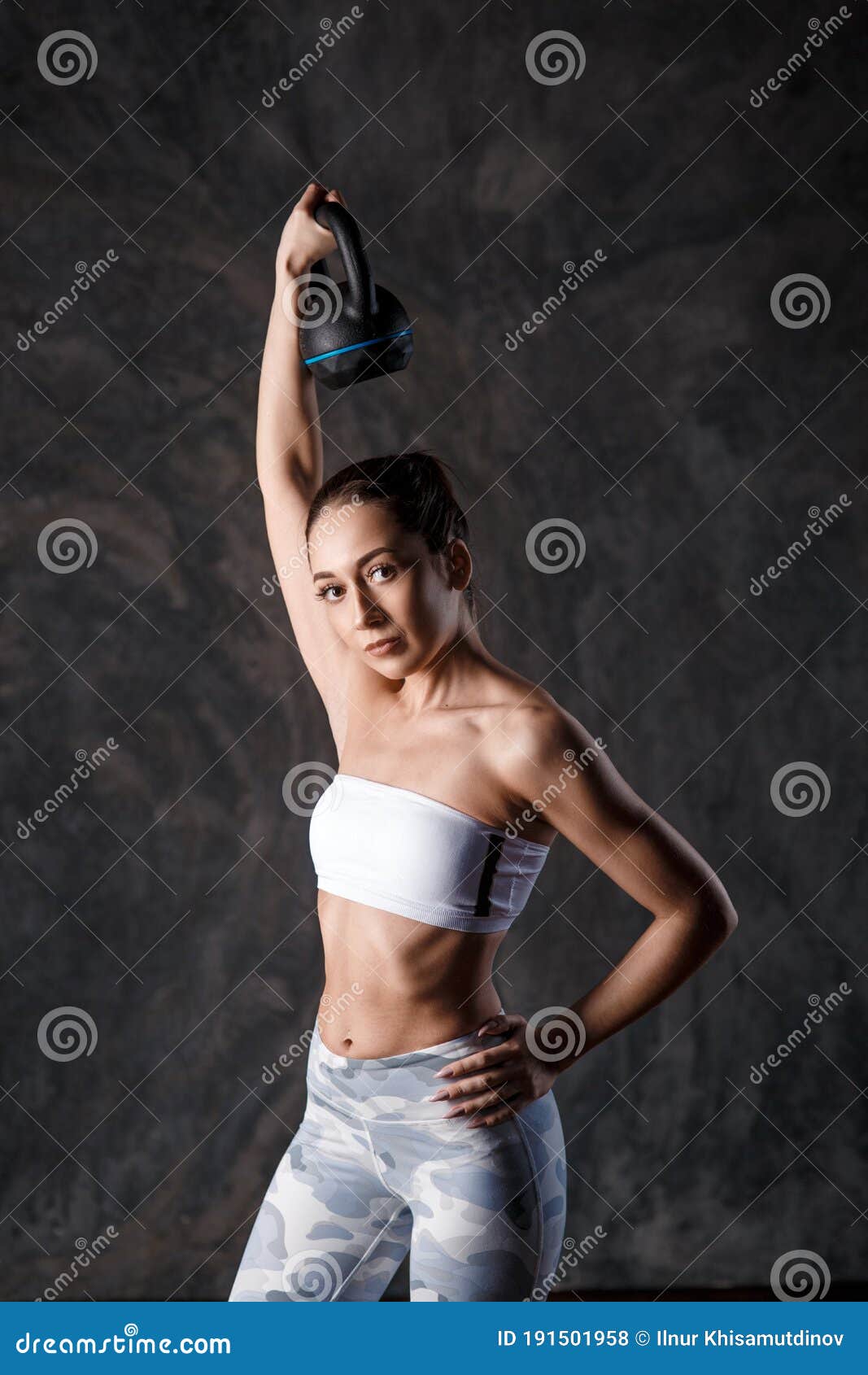 Royalty-Free photo: Photograph of woman in black sport brassiere holding  kettlebell