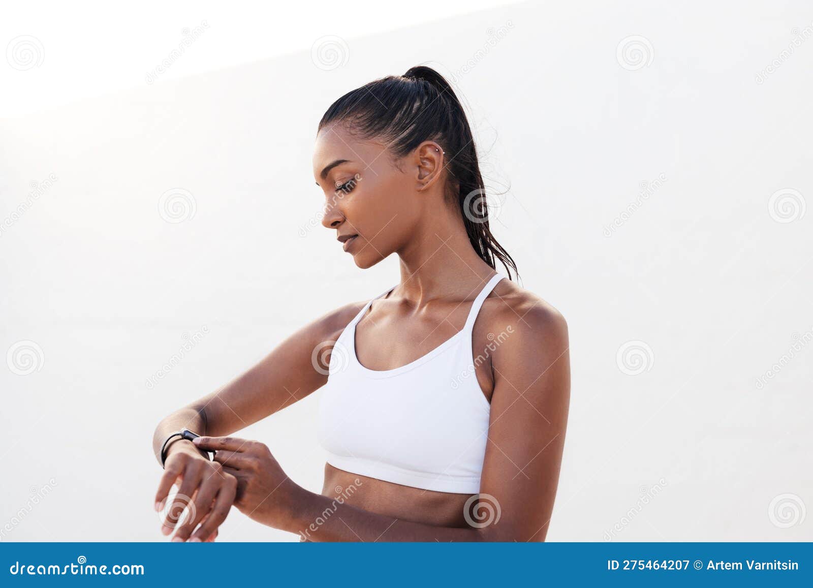 Fitness Female in White Sports Attire Adjusting Smartwatch before a Workout  Stock Image - Image of white, space: 275464207