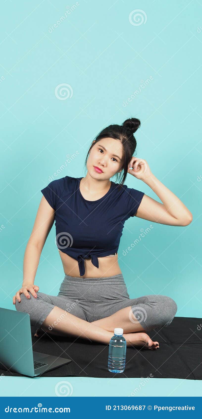 Female fitness influencer doing sit-ups in a white outdoor studio
