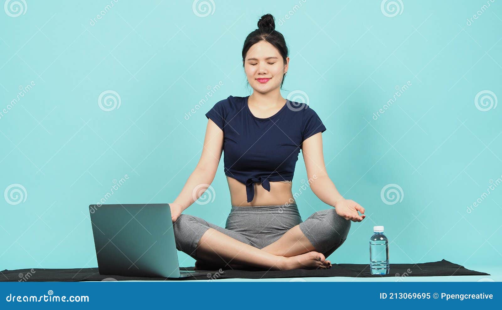 Female fitness influencer doing sit-ups in a white outdoor studio