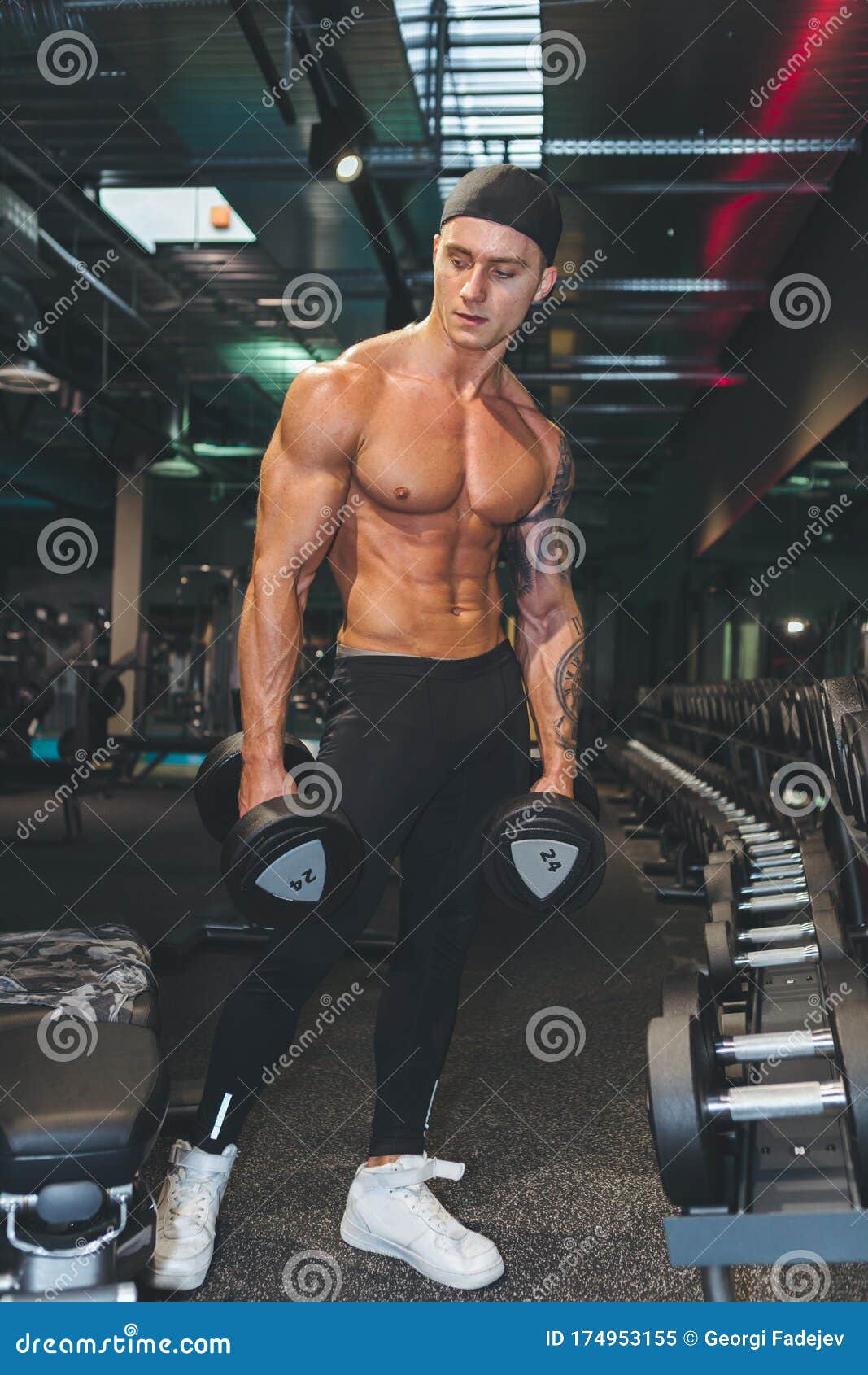 Fitness Instructor In The Sport Room Background. Male Model With Muscular  Fit And Slim Body Stock Image - Image Of Kettlebell, Concept: 174953155