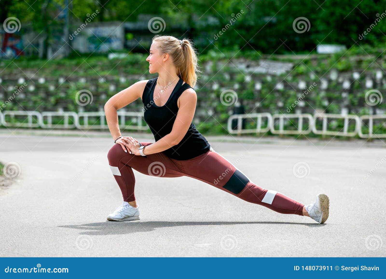fitness lifestyle. young woman warming up before training doing exercises to stretch her muscles and joints. workout at the