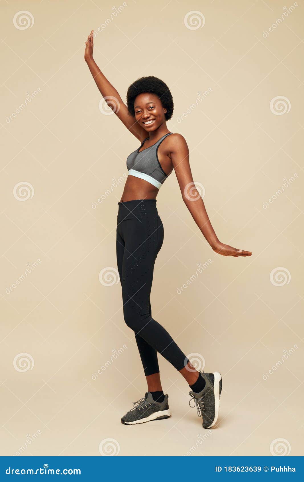 Beautiful toned muscular fitness body of happy smiling African