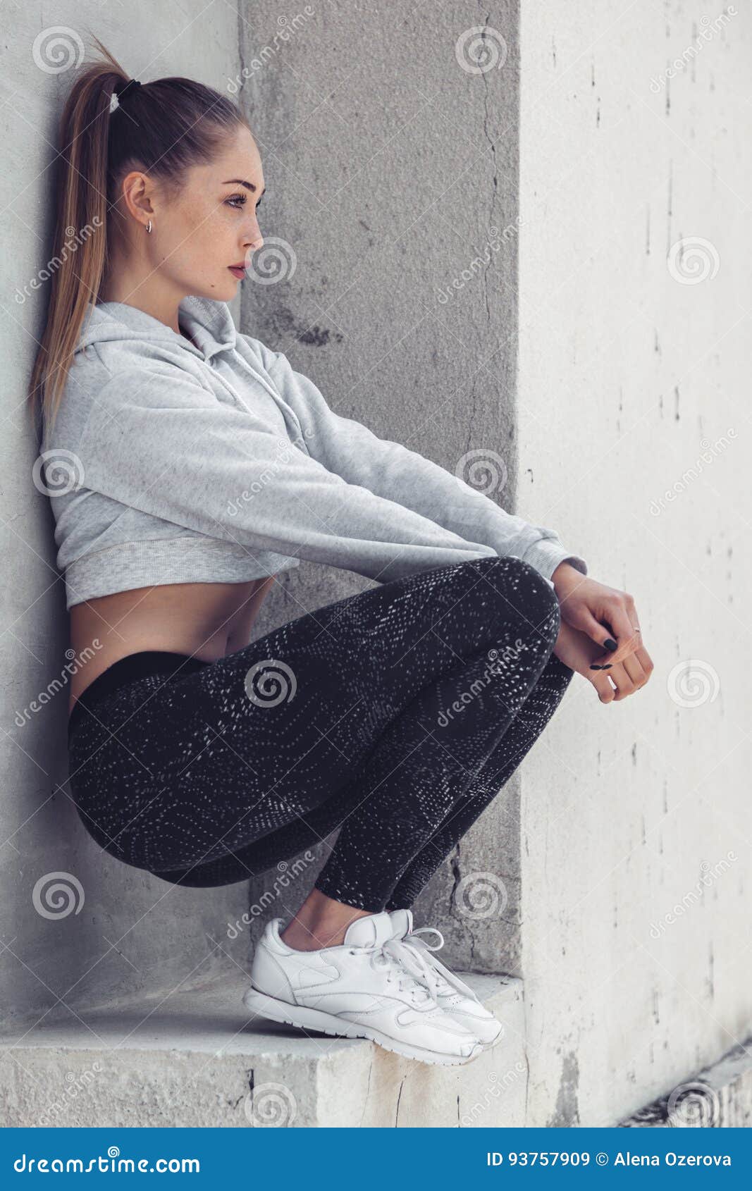 Fitness sporty girl wearing fashion sportswear over street wall