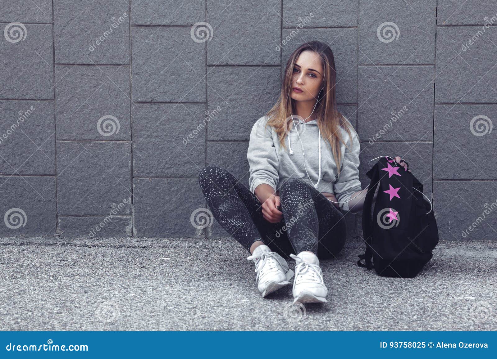 Fitness sporty girl wearing fashion sportswear over street wall