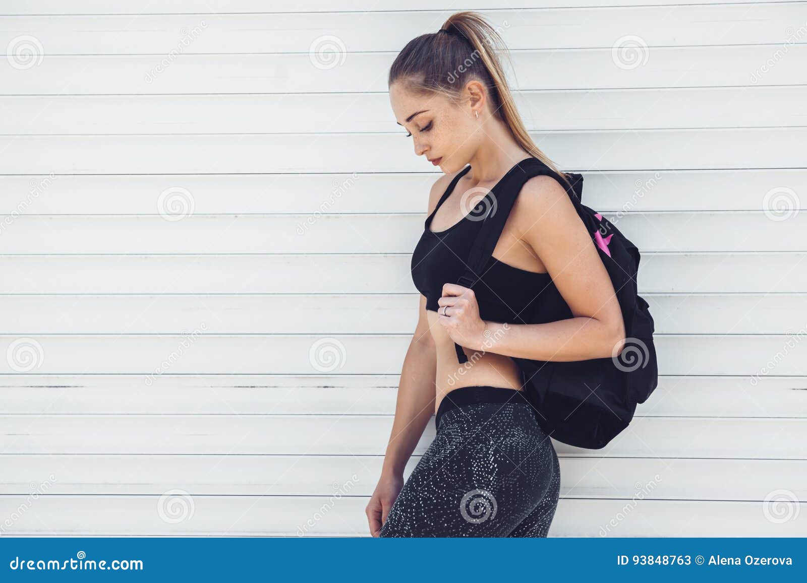 Fitness sporty girl wearing fashion sportswear over street wall