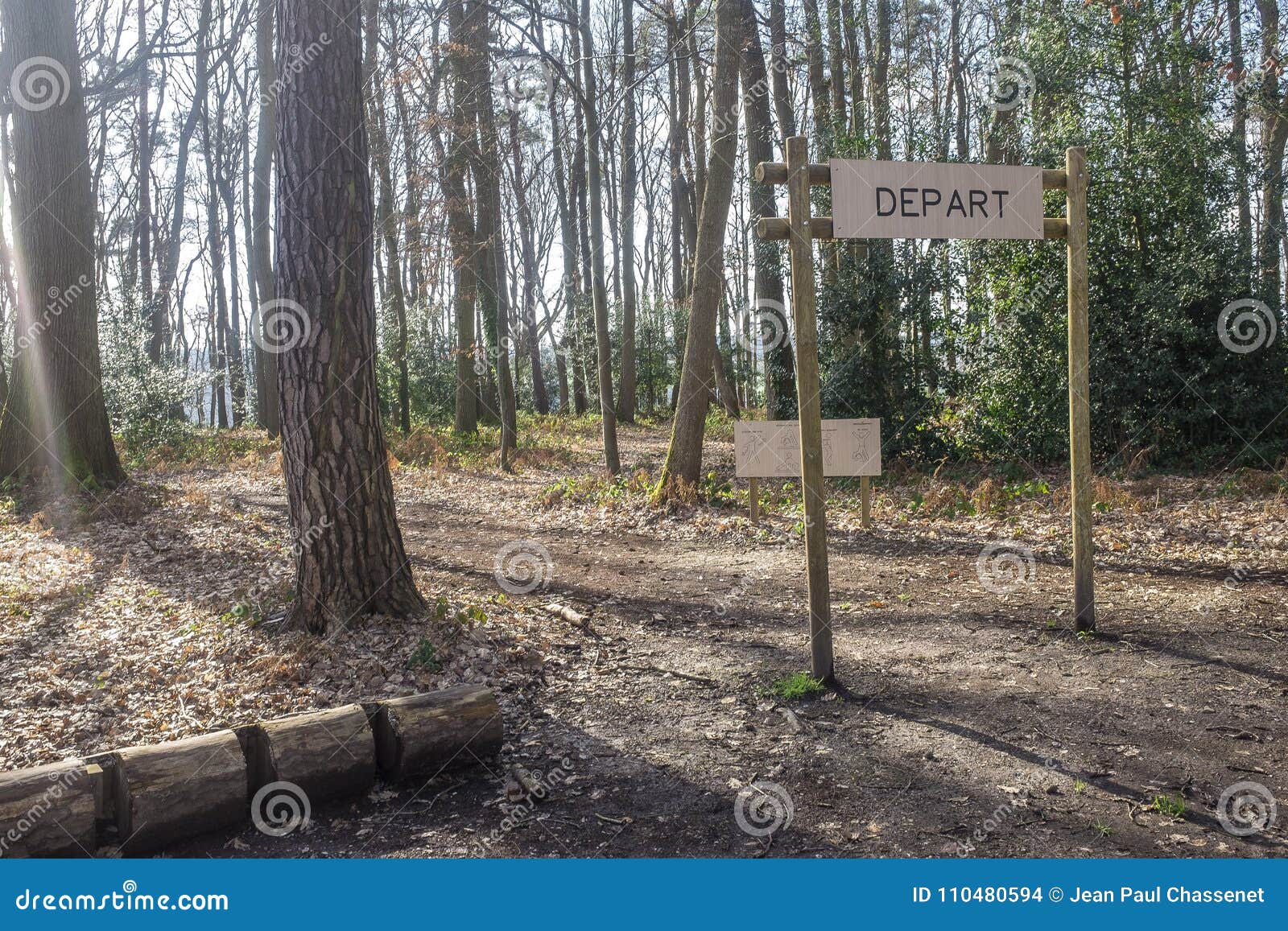 fitness training in forest. sign planted in a forest that indicates `depart, start`