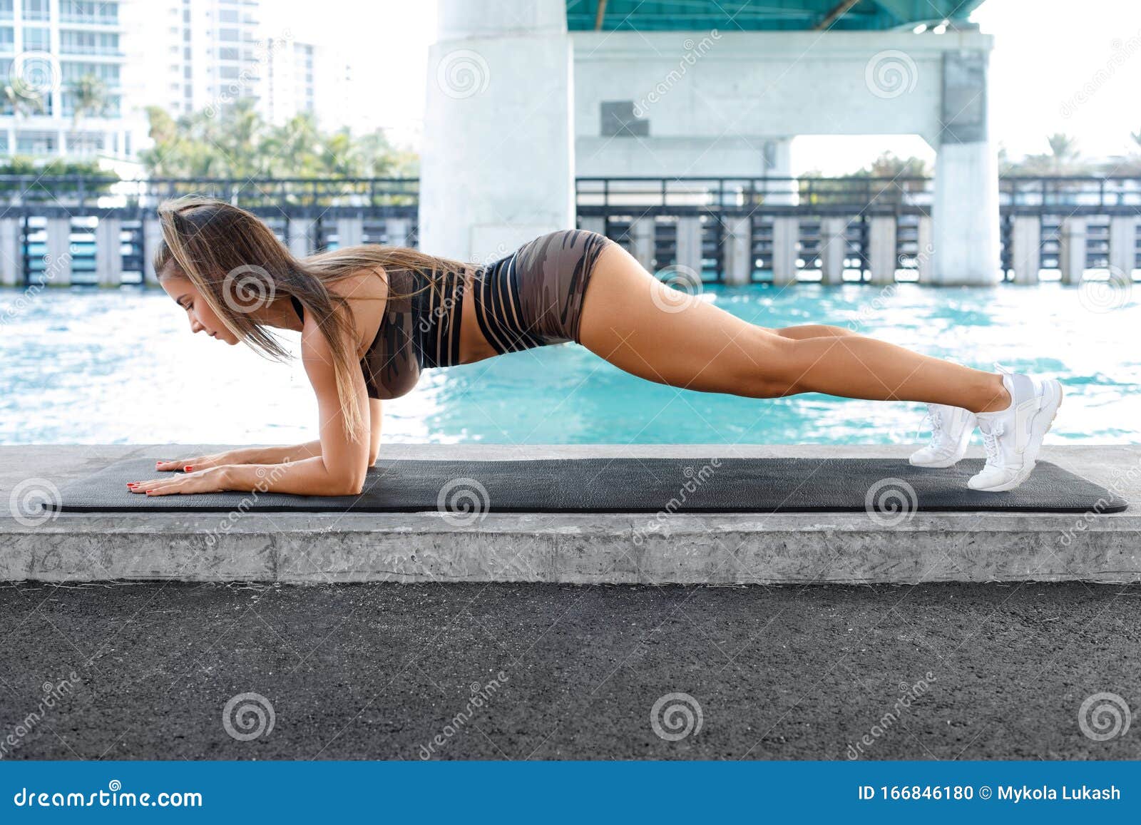 fitness woman doing planking exercise, workout. slim athletic girl training, outdoors