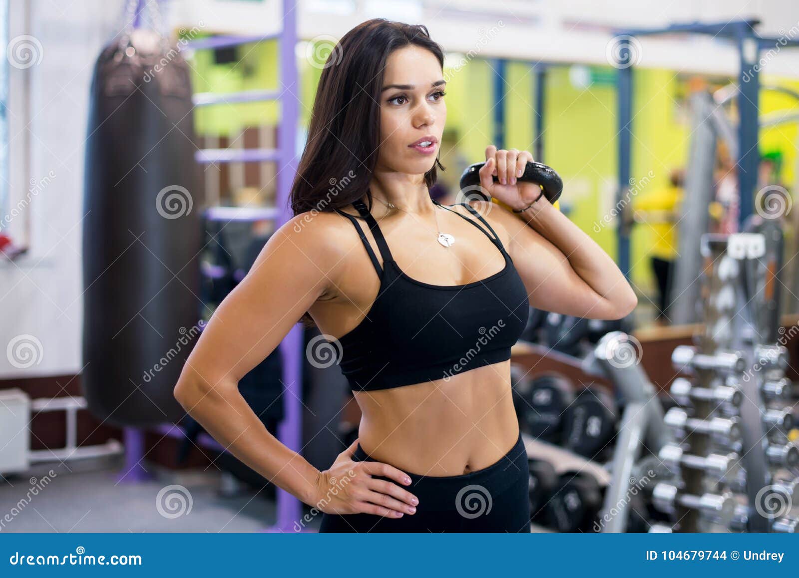 Fitness Woman Doing Shoulder Press Swing Exercise with a