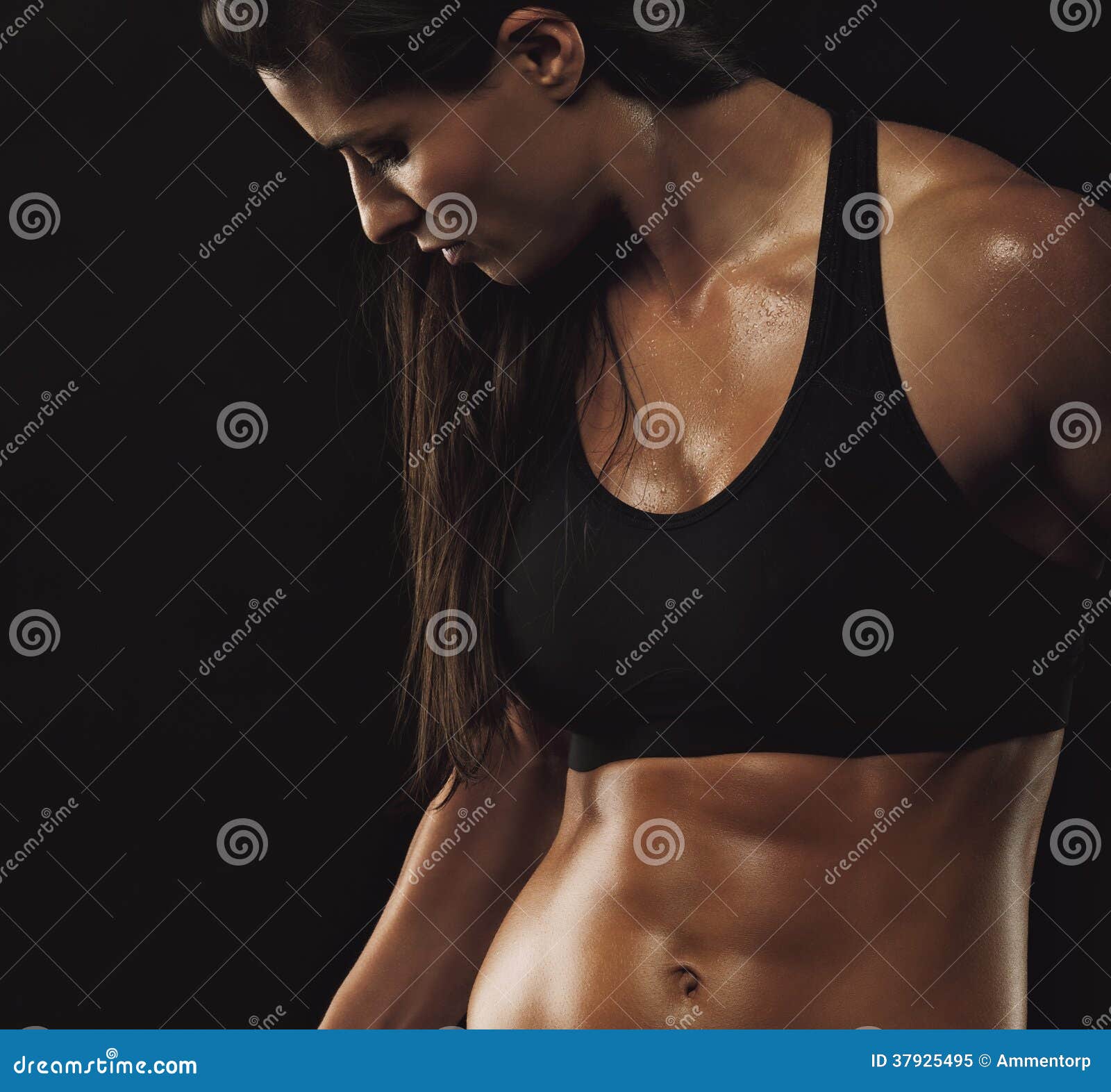 Portrait Of Young Fitness Woman Shows Biceps. Muscular Female Body