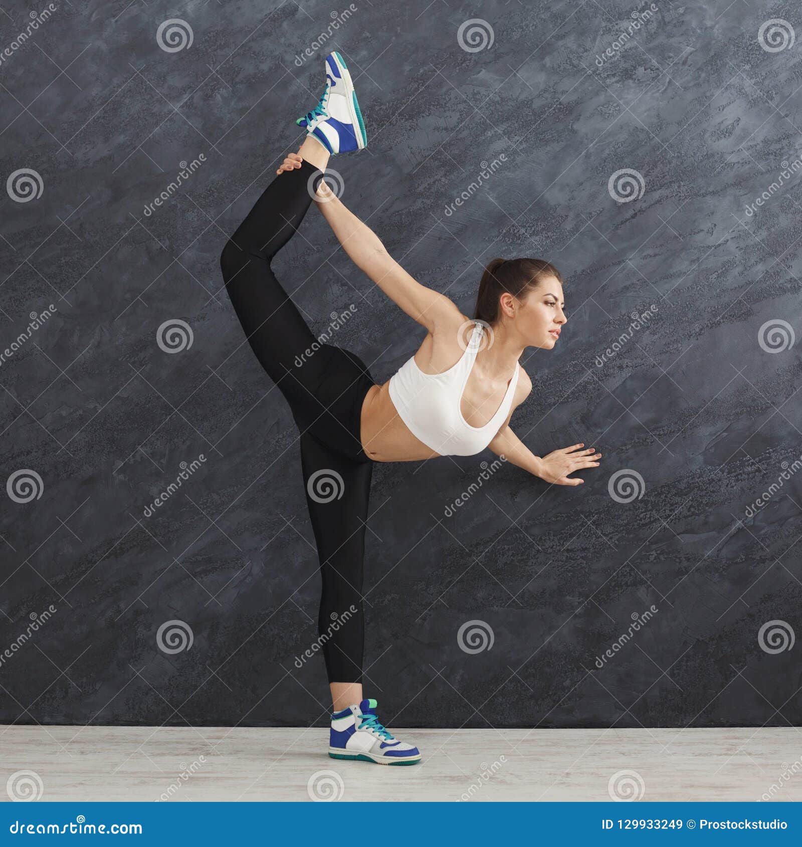 Fitness Woman Stretching at Grey Background Indoors Stock Image - Image ...