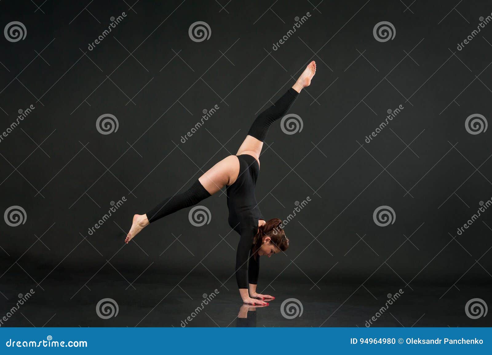 Fitness Woman Training in Dark Studio. Young Girl Posing on Black ...