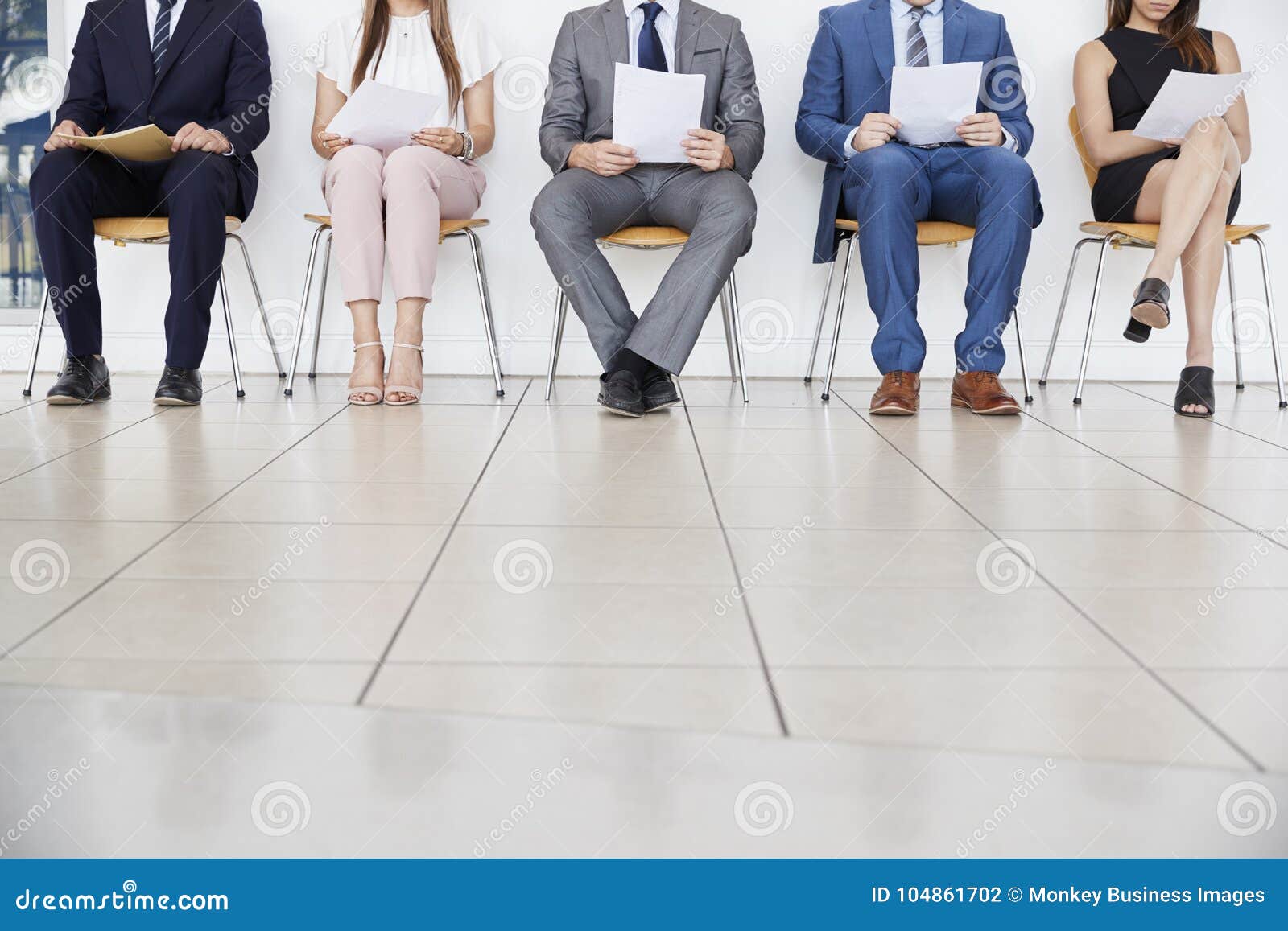 five candidates waiting for job interviews, front view, crop
