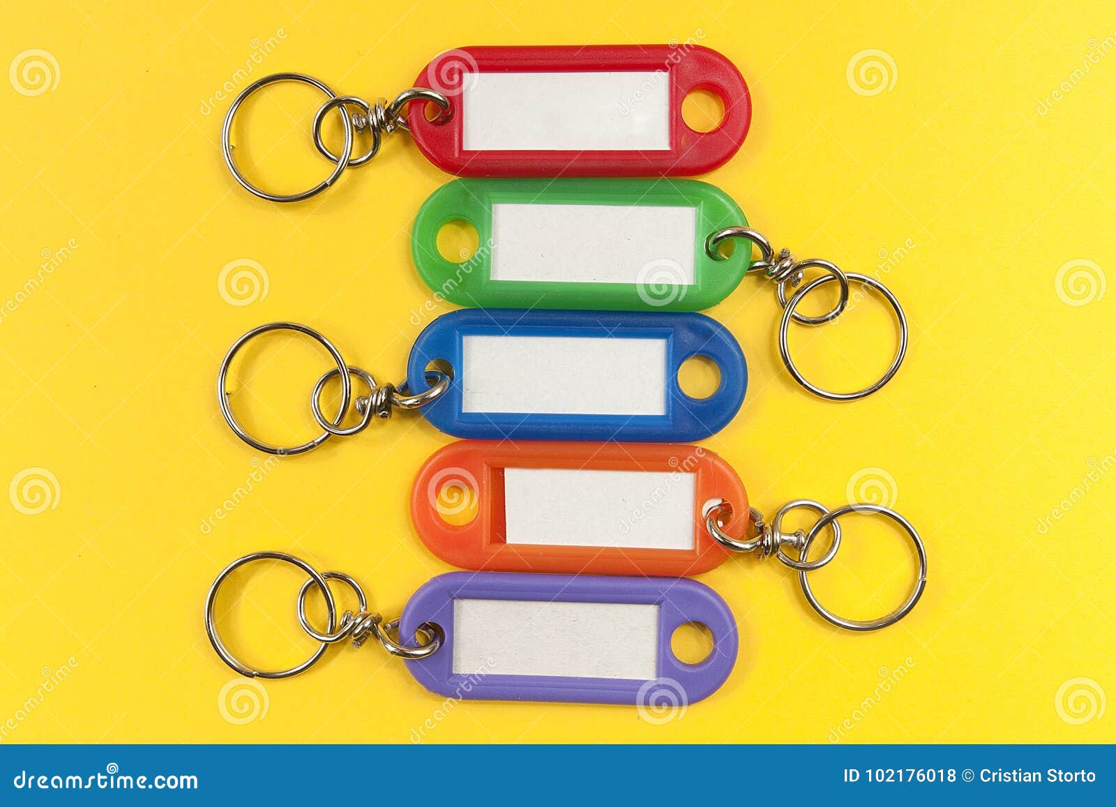 Five Colored Key Holder with White Label on Yellow Background Stock