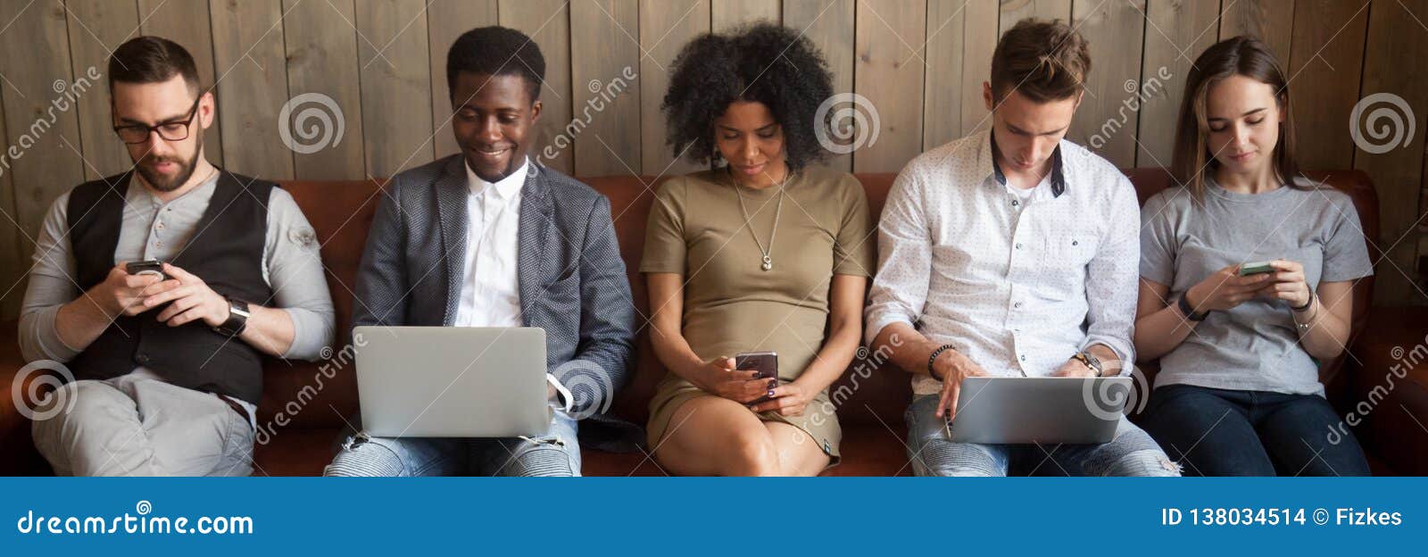 five diverse businesspeople girls guys sitting on couch using gadgets